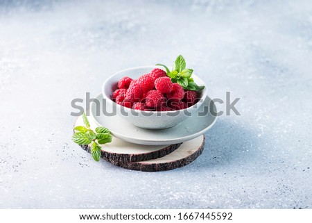 Concept of vegan food with fresh raspberry, minimal style and selective focus