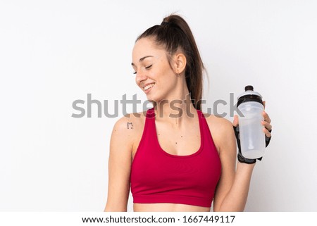 Young sport brunette woman over isolated white background with sports water bottle