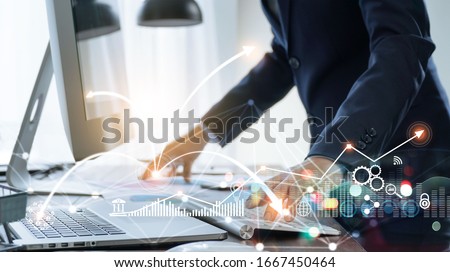Businessman using computer and laptop, Management global structure networking and data exchanges customer connection on workplace, Business technology and digital marketing network concept. Royalty-Free Stock Photo #1667450464