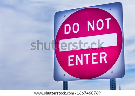 "Do not enter" road traffic street sign; with white letters and symbols inside a red circle on a square sign