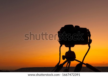 Silhouette of Camera on Tripod at Sunset 
