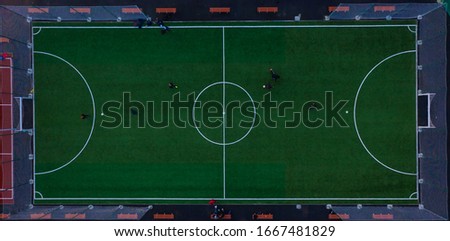 stadium basketball court with people playing view from top of drone