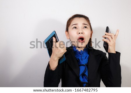 Laughing business woman wearing blue shirt and suit holding smartphone on white background. Business concepts. Copy space for text.