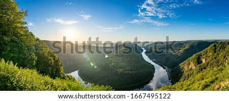 Sunrise flare over Saar river valley near Mettlach. South Germany  Royalty-Free Stock Photo #1667495122