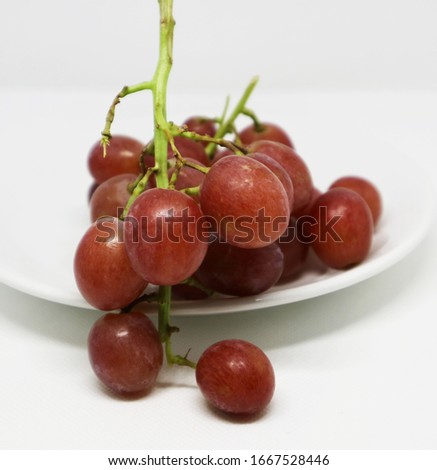 Sweet pink grapes, isolated on a white background