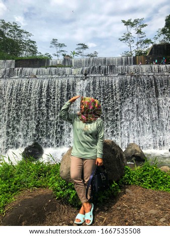 Hijab woman get photo shoot in Watu Purbo waterfall.