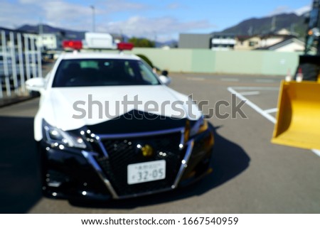 Bokeh image of Japanese police car