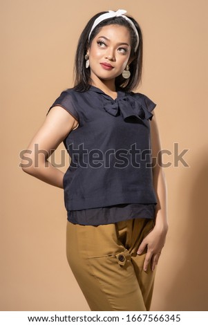 Asian woman with retro outfit on pastel background