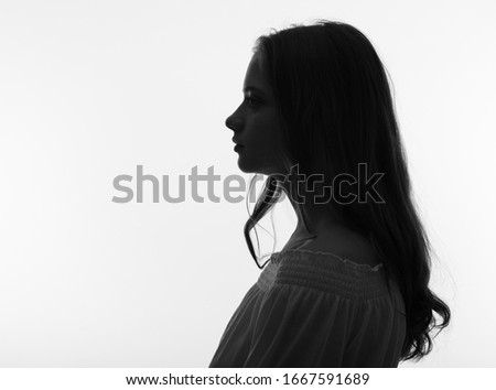 Portrait of a young beautiful woman in profile.