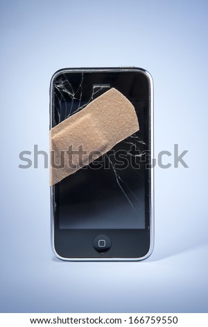 Smart Phone with cracked screen, fixed with sticking plaster.