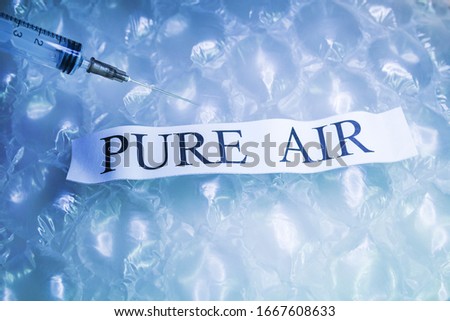 Blue Plastic bubble wrap pattern with pure fresh air inside for breath.Syringe filling.The problem of ecological of not enough fresh air around.