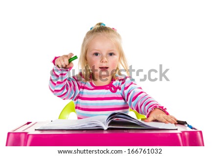 Child drawing with crayons isolated on white
