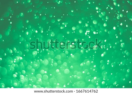 Abstract bokeh lights with light green background

