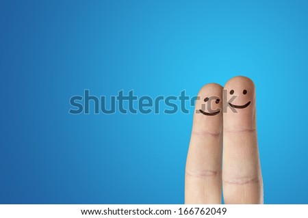Painted finger smiley on blue background
