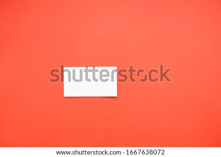 a white business card on a red background is a simple diagram. business card
