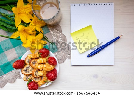 Valentine's day strawberry cookies hearts with coffee, with yellow flowers on a napkin, Notepad with a pen, a note with the text Good morning, I love you happy holiday mother woman Easter