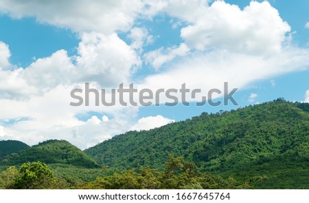 Green mountains and beautiful sky clouds under blue sky. Outdoor landscape for natural background.