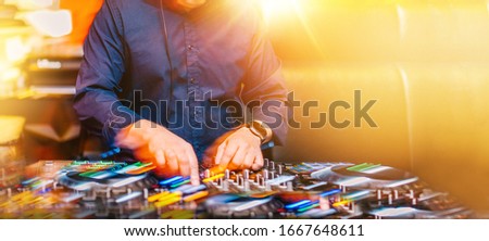 Blurred Long Exposure Dj mixing music loops in motion blur