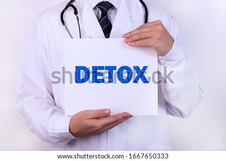 Doctor holding a card with Detox medical concept