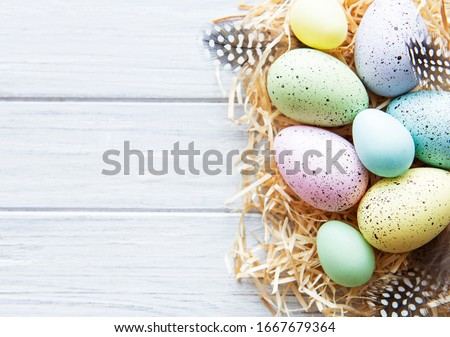 Colorful Easter eggs on white wooden background.  Easter holiday concept, flat lay, top view. Royalty-Free Stock Photo #1667679364