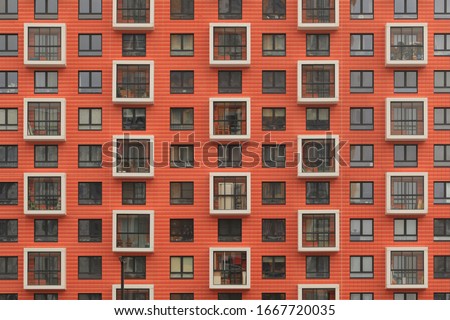 New orange building facade in housing complex "Salaryevo Park. PIK", Butovo, Moscow city, Russia. Modern style in architecture. House in dormitory area of Moscow. Urban landmark. Symmetry in exterior