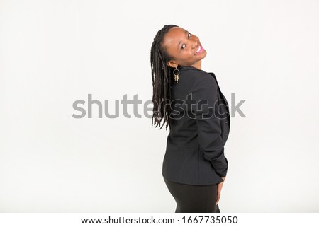 beautiful young african woman in a black suit on a white background