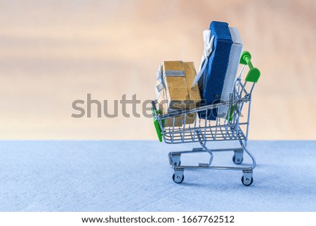 Gift boxes in the shopping cart. Close-up view. Price changes of gift boxes. Increasing or decreasing gift. Chosen gifts for holidays, universally
