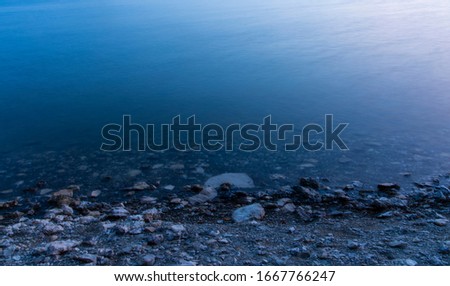 long exposure water twilight phantom blue stone reservoir coast waterfront area peaceful idyllic background wallpaper scenic view concept picture with empty copy space for your text here 
