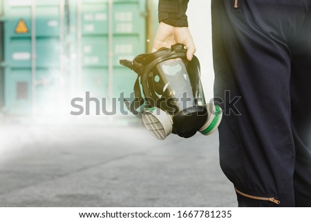 
Male industrial technician who holds a respirator mask, an ammonia odor mask, NH3 to control and fix leaks inside the factory's container : Copy Space
 Royalty-Free Stock Photo #1667781235