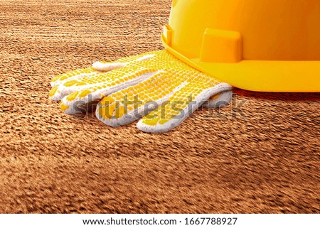 Glove and safety helmet on the floor. Labor day concept