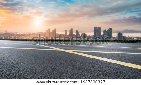 Asphalt road and Qingdao urban construction skyline

