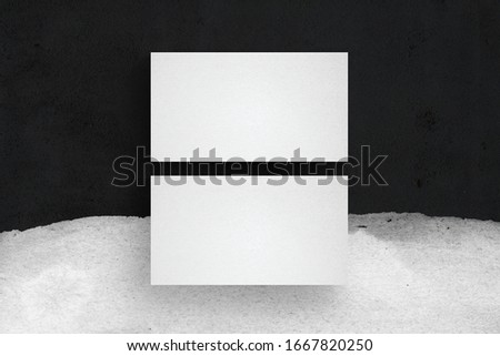 Minimal business card mockup. Black concrete background with white painting brushes