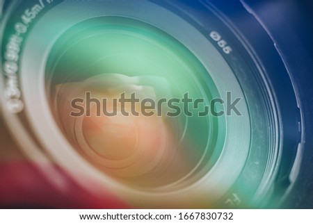 Close up Beautiful camera lens with multi colored light. Background pattern for design.	