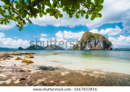 El Nido, Palawan, Philippines. Leaves framed picture of Pinagbuyutan island and beautiful tropical coastline seascape