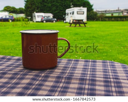 Close-up photo of metal mug, brown drinking mug on the table in camping,