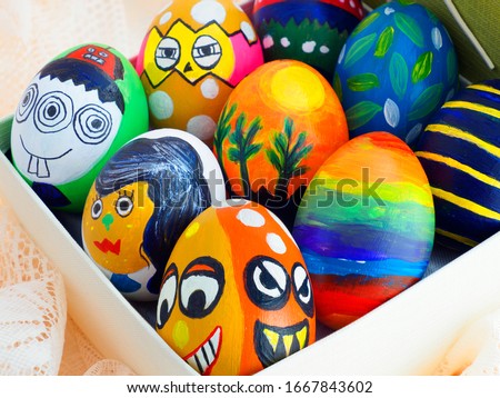 Easter eggs, colorful painted handmade many cute styles in a gift box and placed on lace fabric