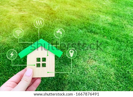 Miniature home and symbols of public utilities. Choosing a house to buy, assessing the cost and condition of the building. Location in the city. Repair and renovation, maintenance services. Royalty-Free Stock Photo #1667876491