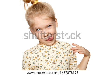 Portrait of funny little girl making a face, isolated over white background with copy space.