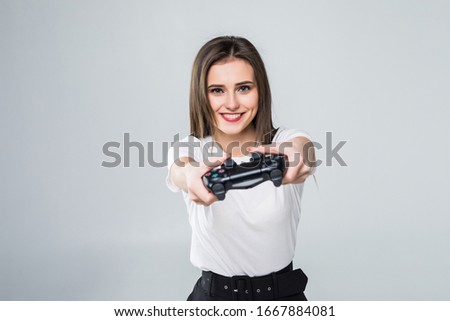 Young pretty woman over isolated background playing at videogames