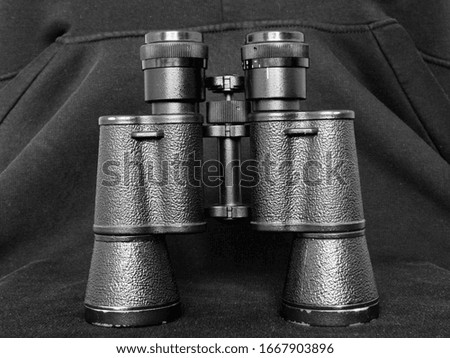 
Army binoculars with black body closeup on a black background