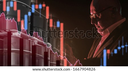 A man is studying the oil and gas sector. An investor explores the oil industry. Concept - reports of oil companies. Charts next to the barrels on a dark background. Crude Oil Price Drop