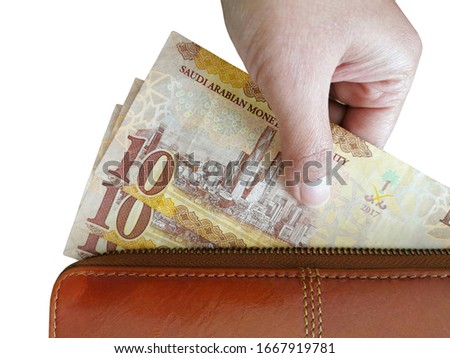 10 saudi riyal banknotes in wallet isolated on white background. Selective focus.