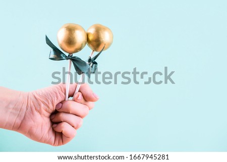 Delicious and beautiful cake pops on an abstract background. Delicious dessert for St. Patrick's Day
