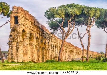 Ruins of the iconic Parco degli Acquedotti, Rome, Italy. The public park is named after the 7 ancient aqueducts that go through it Royalty-Free Stock Photo #1668027121