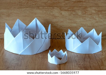Paper crown. Three paper white crowns. Royal family, royal dynasty concept