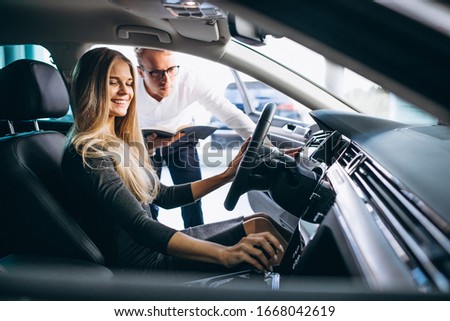 Young woman testing a car from a car showroom