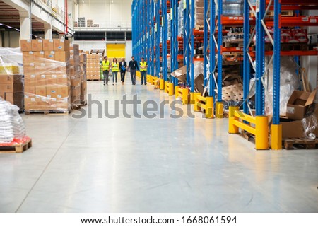 Managers and workers in warehouse