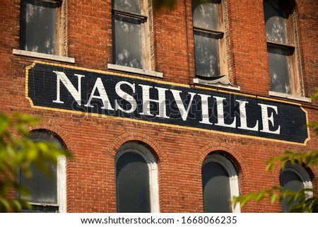 City of Nashville Tennessee USA sign painted on the side of a brick building
