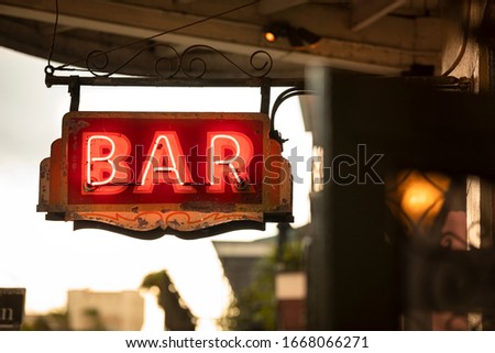 Neon bar sign hangs along Bourbon Street in the French quarter of New Orleans Louisiana USA in the French quarter of New Orleans Louisiana USA