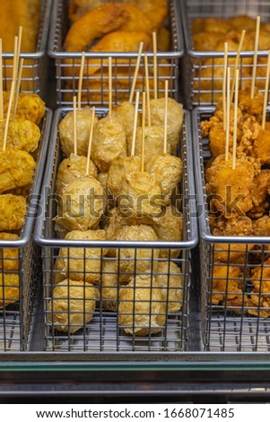 Vertical photo of fish ball skewers at street food market